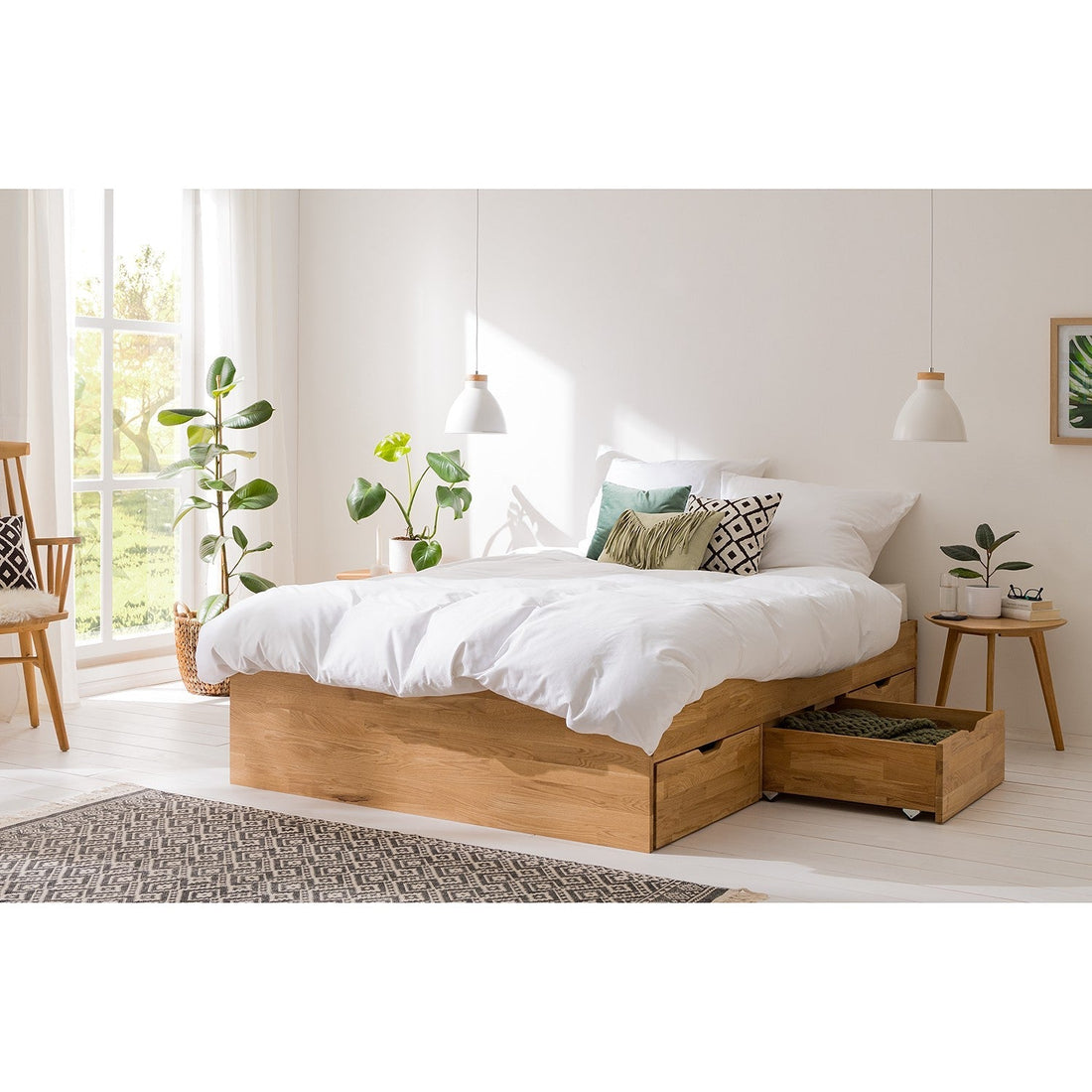 Massief eiken bed met opberglades in een lichte, minimalistische slaapkamer.